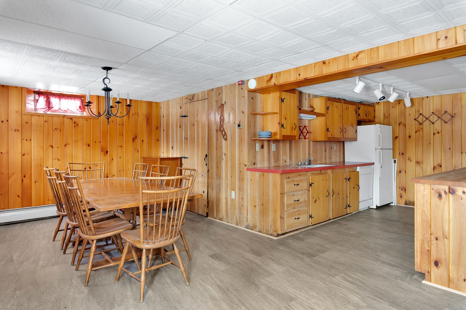 A kitchen with a table and chairs and a refrigerator