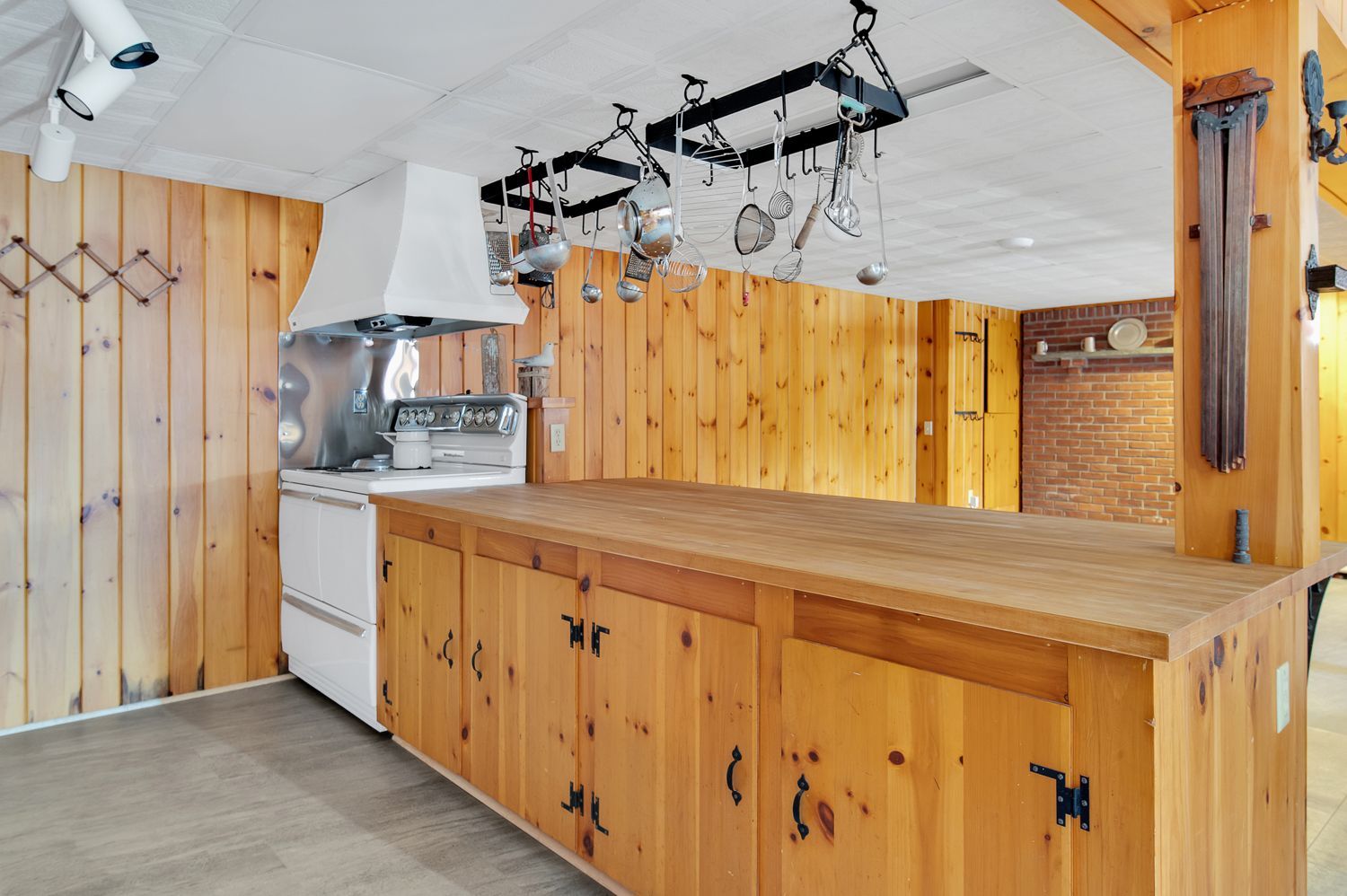 A kitchen with wooden cabinets and a large island