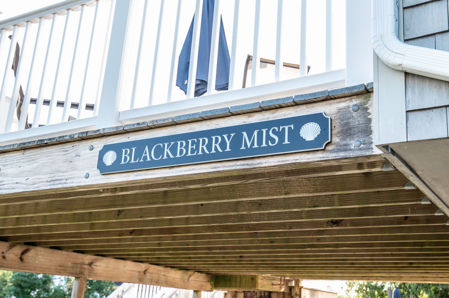 A wooden deck with a sign that says blackberry mist on it.