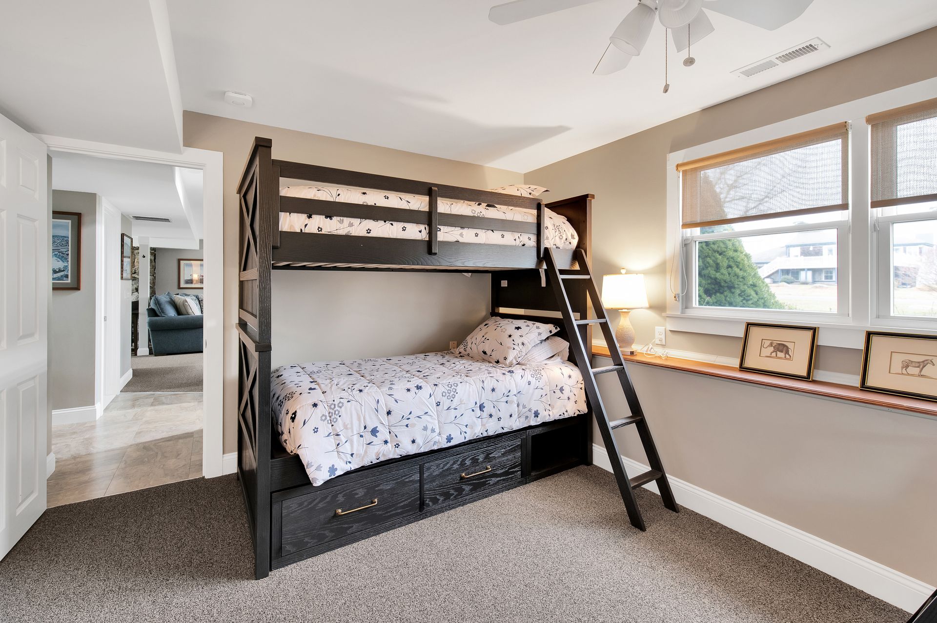 A bedroom with a bunk bed and a ladder.