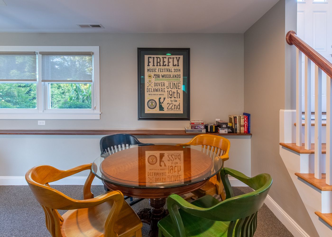 A room with a table and chairs and a firefly poster on the wall.