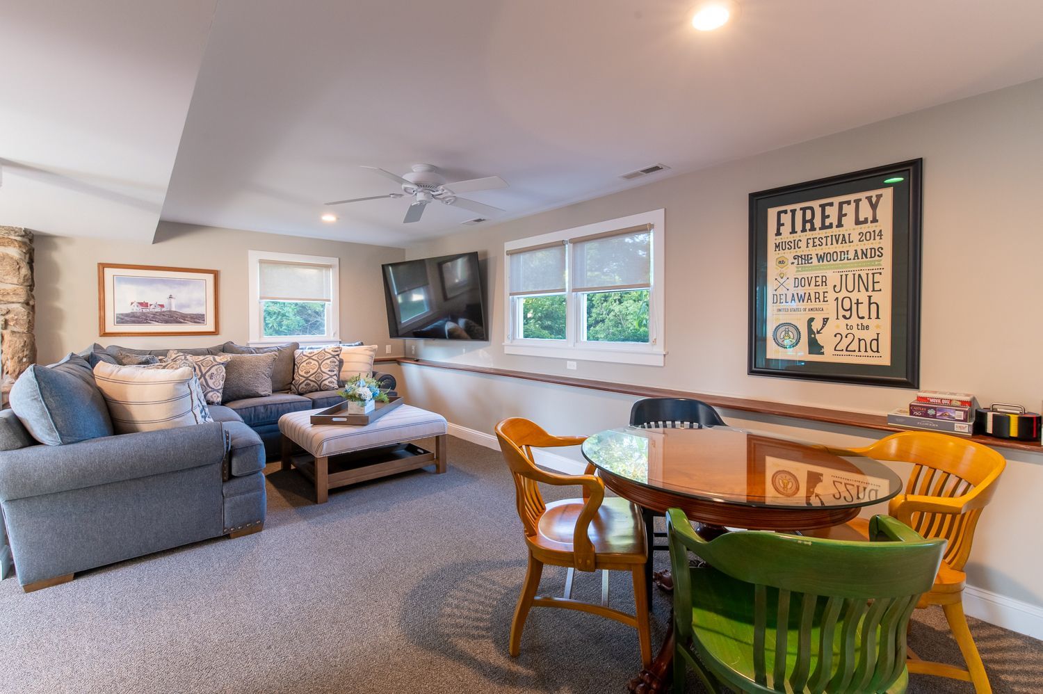 A living room with a couch , table , chairs and a television.