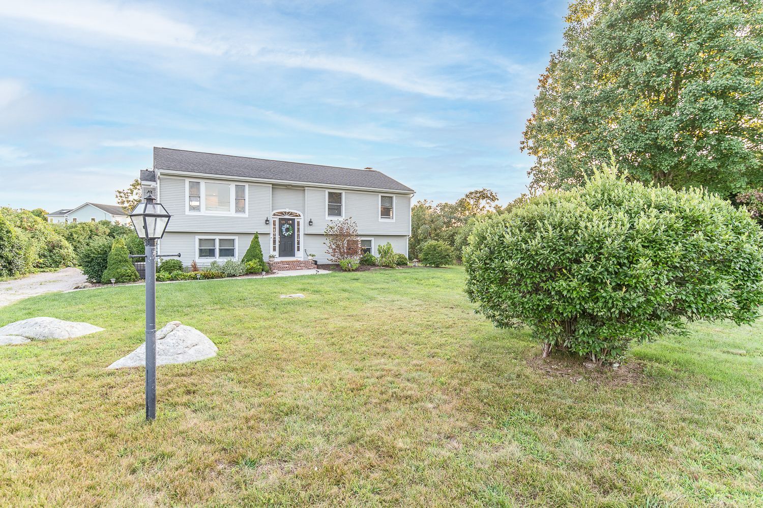 A large white house with a large lawn in front of it.