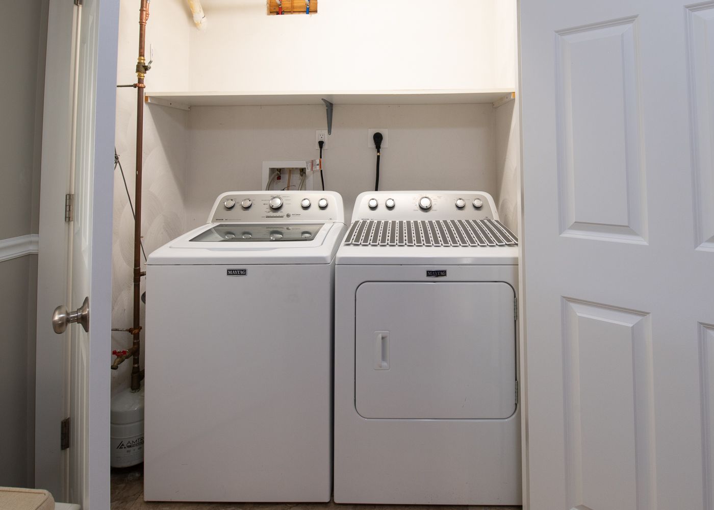A laundry room with a washer and dryer in it.
