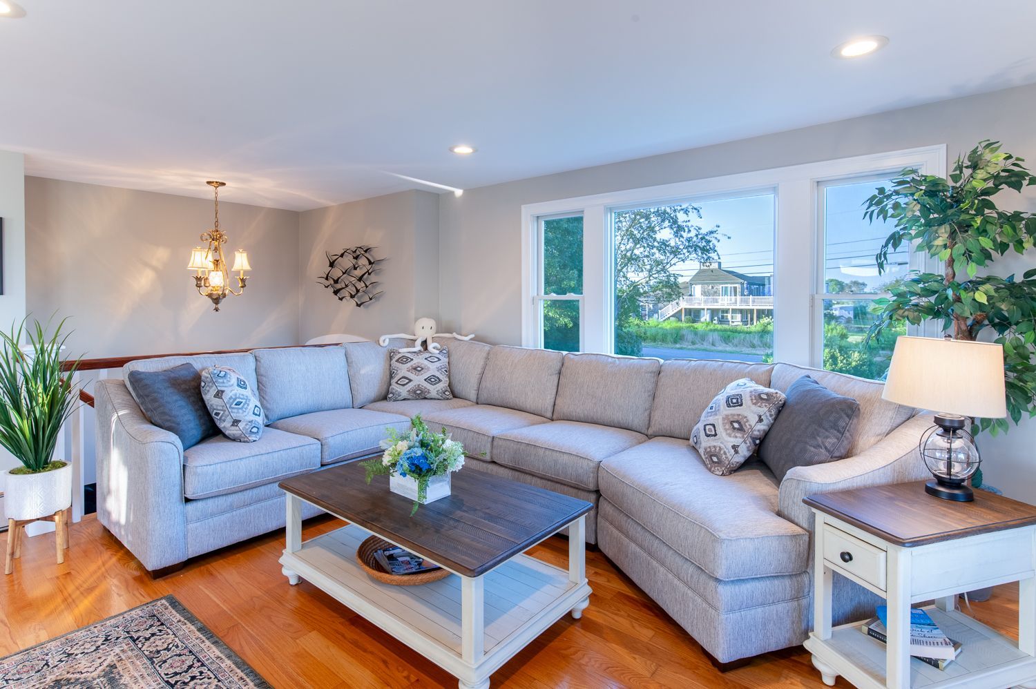 A living room with a large sectional couch and a coffee table.