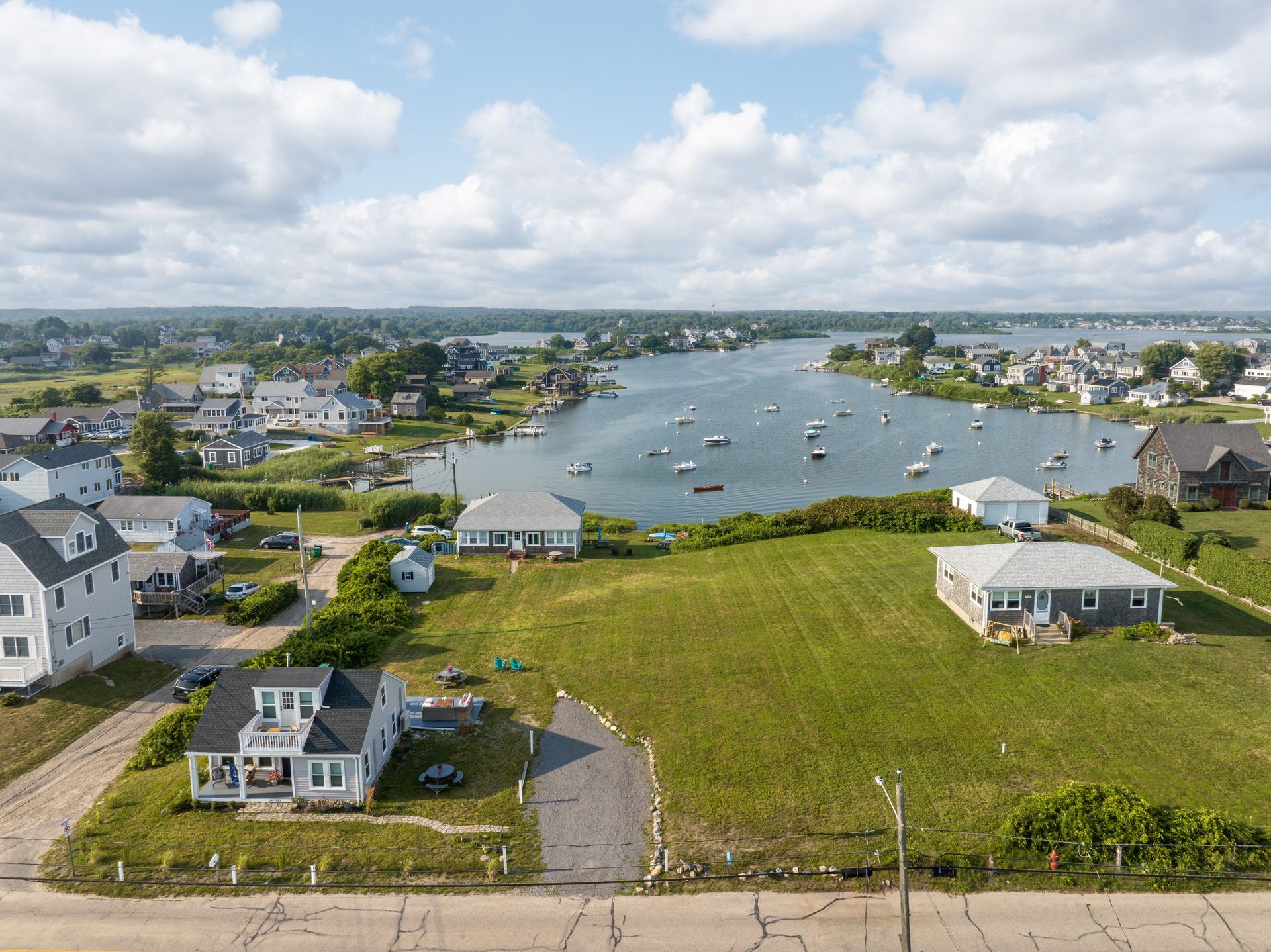 An aerial view of a residential area with a river in the background.