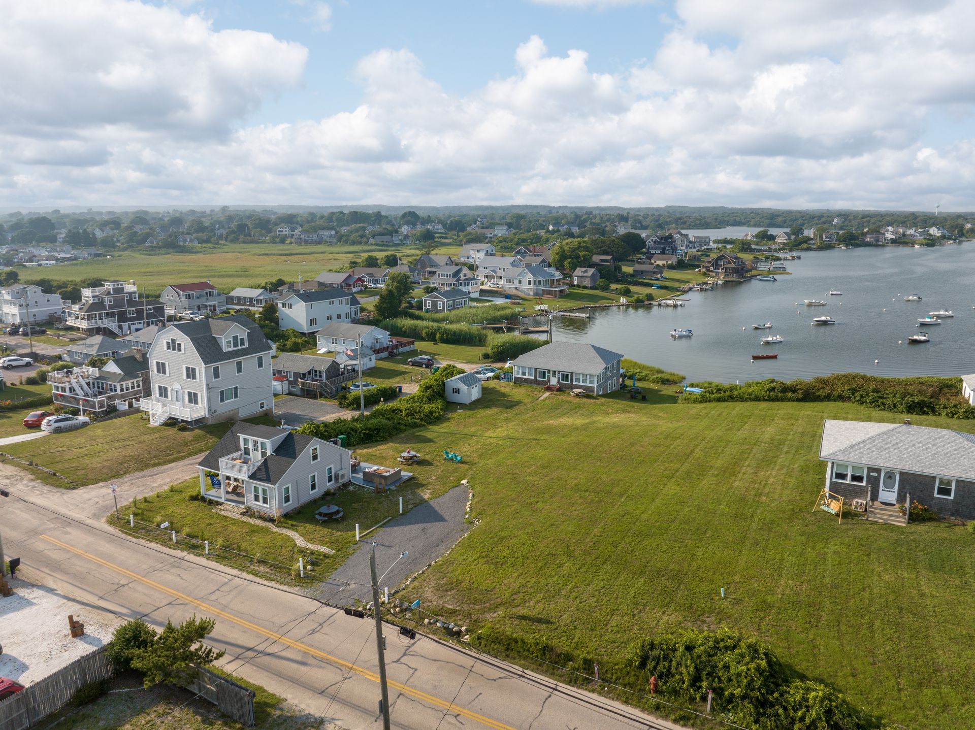 An aerial view of a residential area next to a body of water.