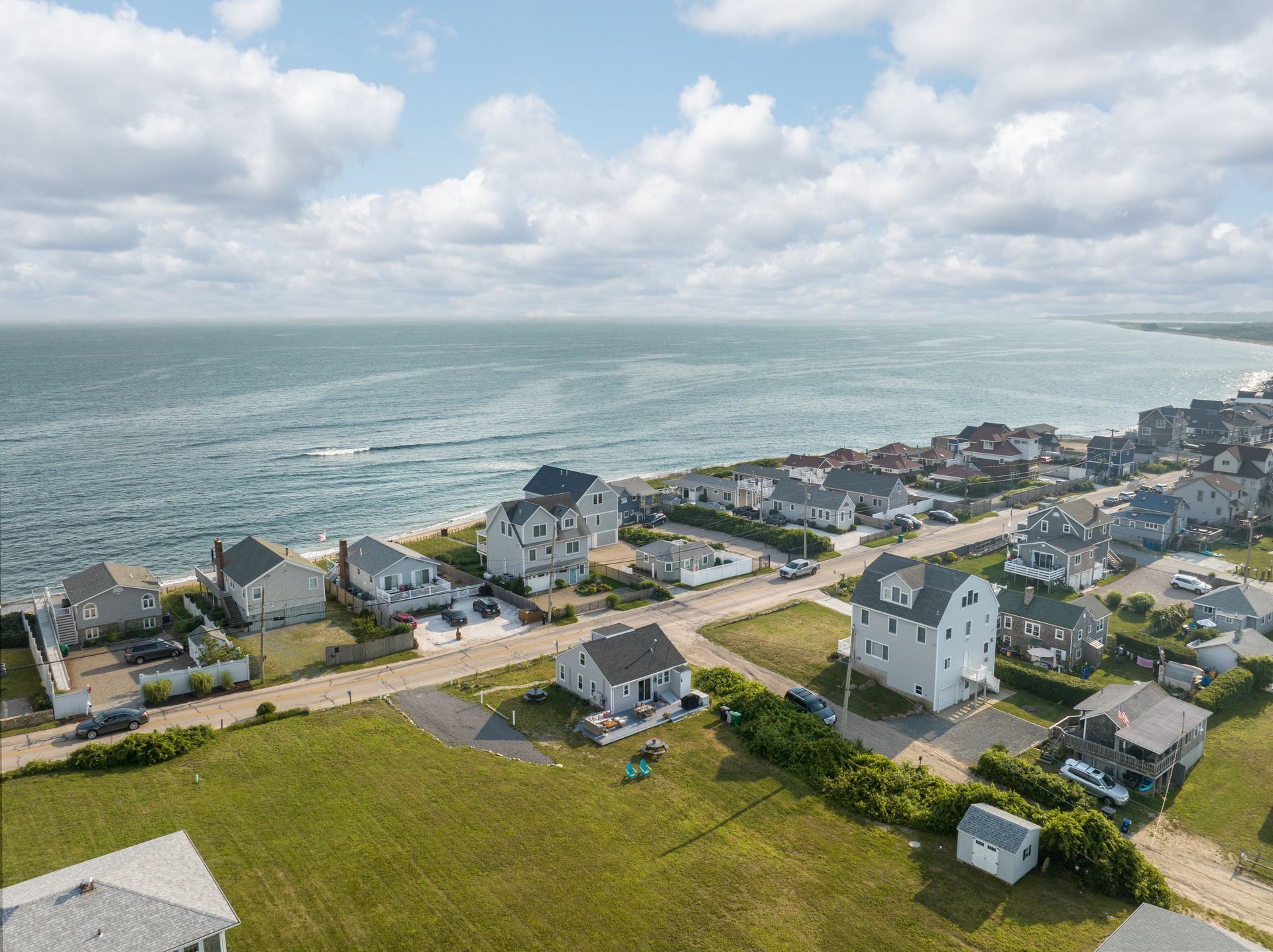 An aerial view of a residential area next to the ocean.
