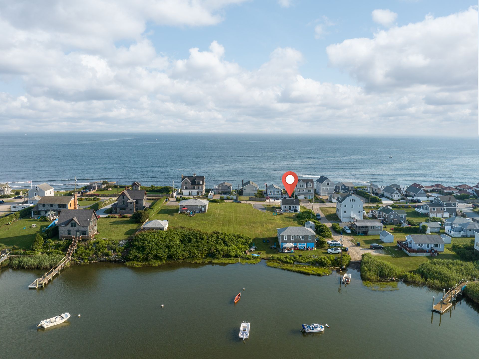 An aerial view of a residential area next to a body of water.