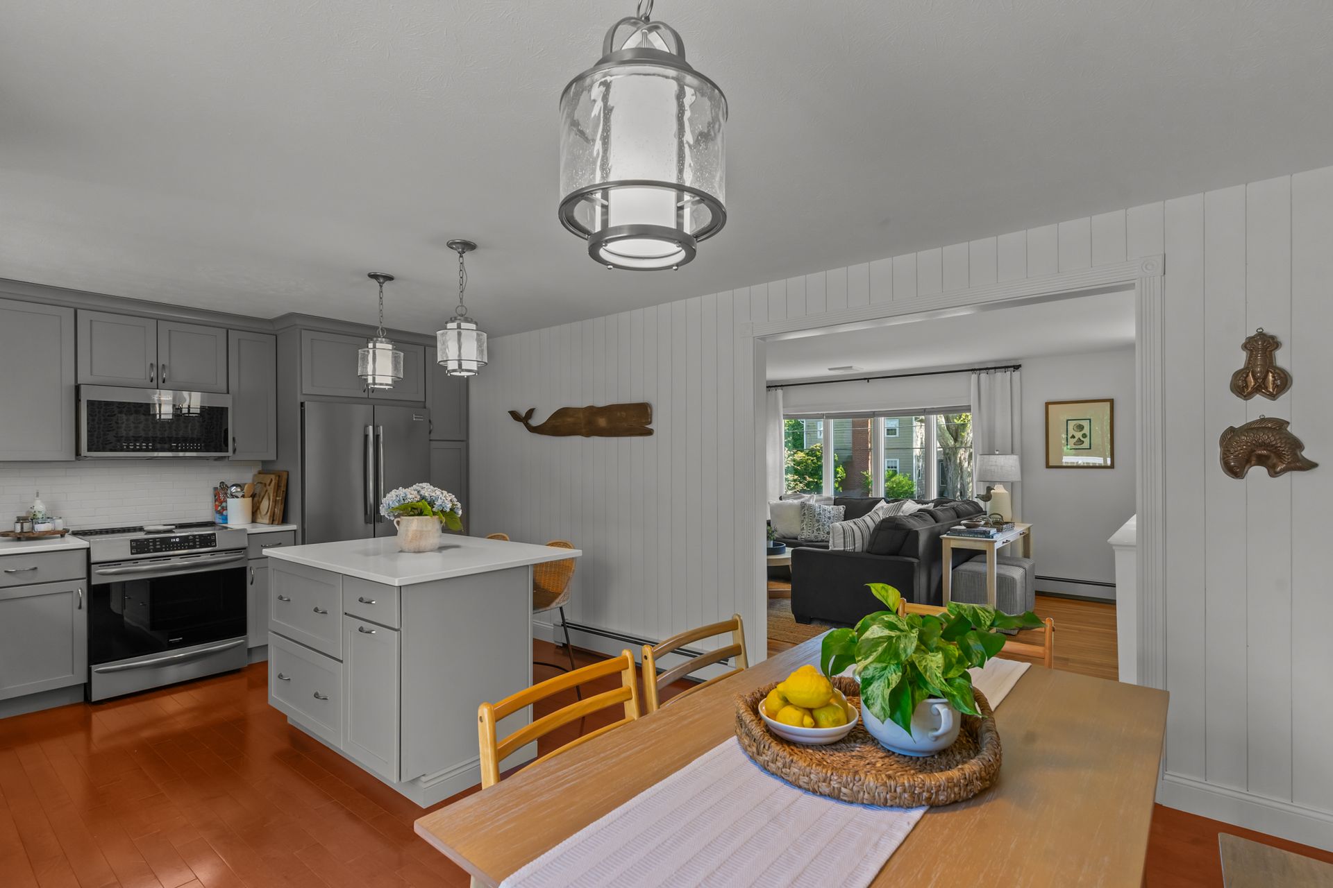 A kitchen and dining room in a house with a table and chairs.