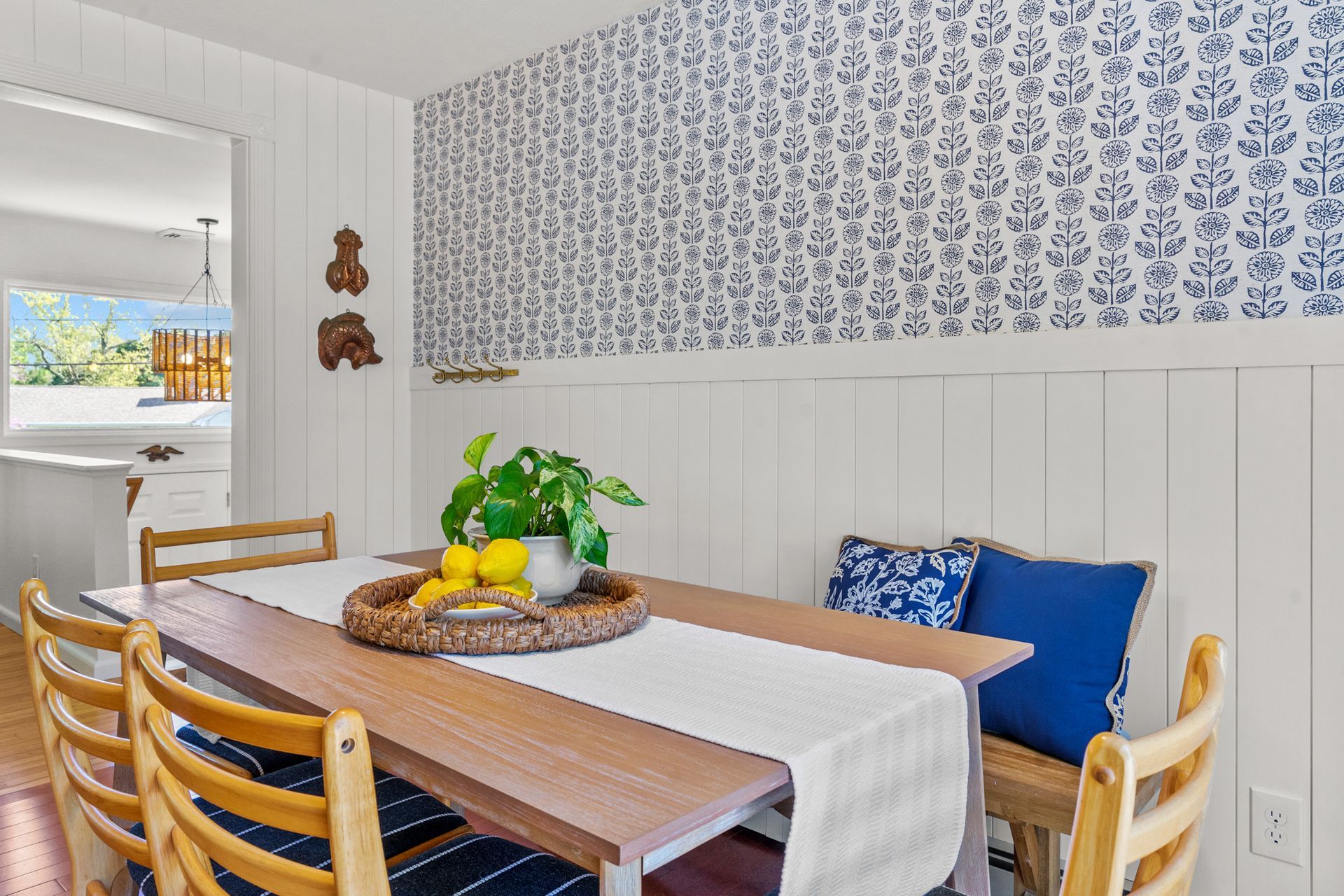 A dining room table with a tray of lemons on it.