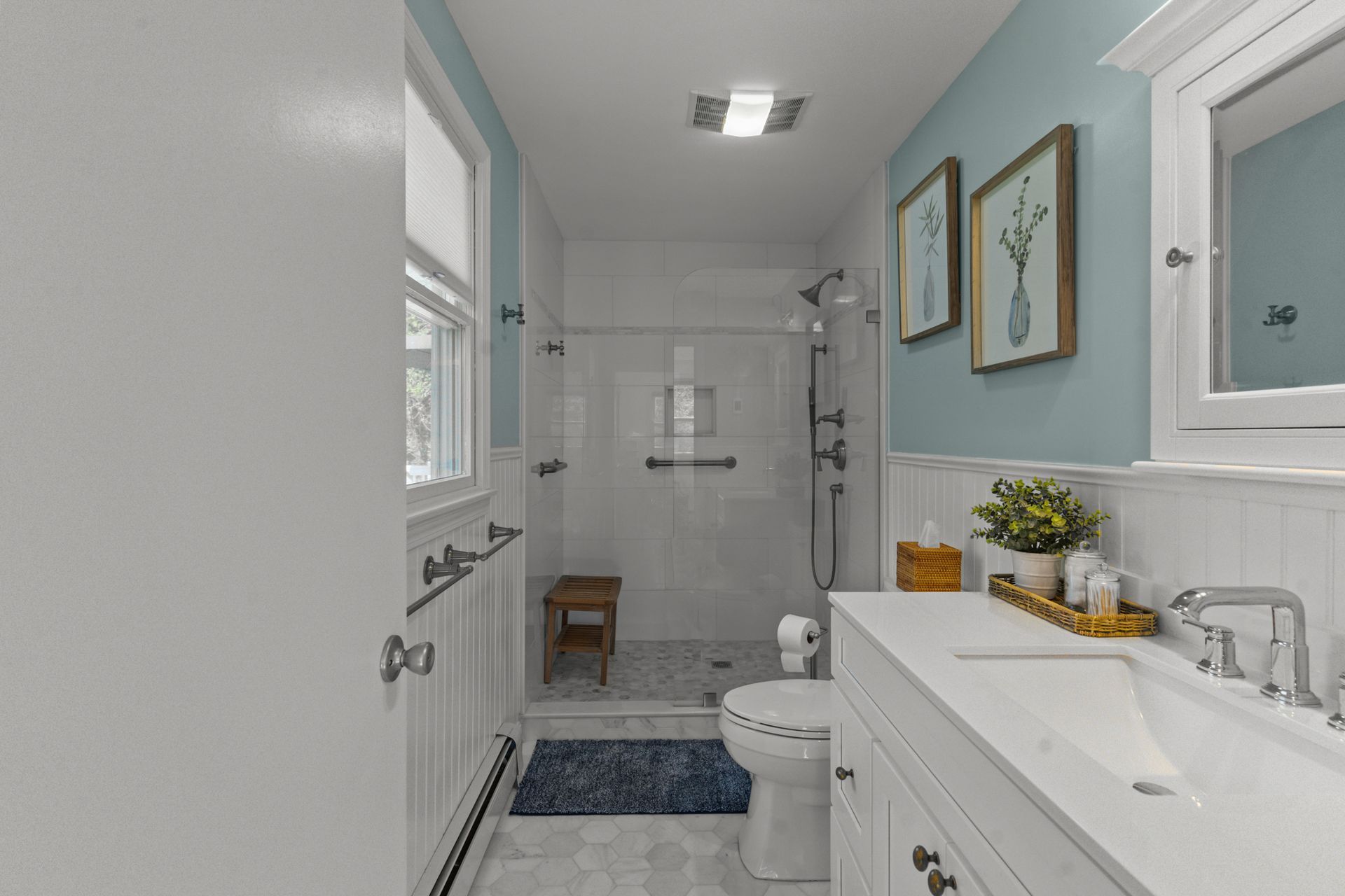 A bathroom with a toilet , sink , and shower.