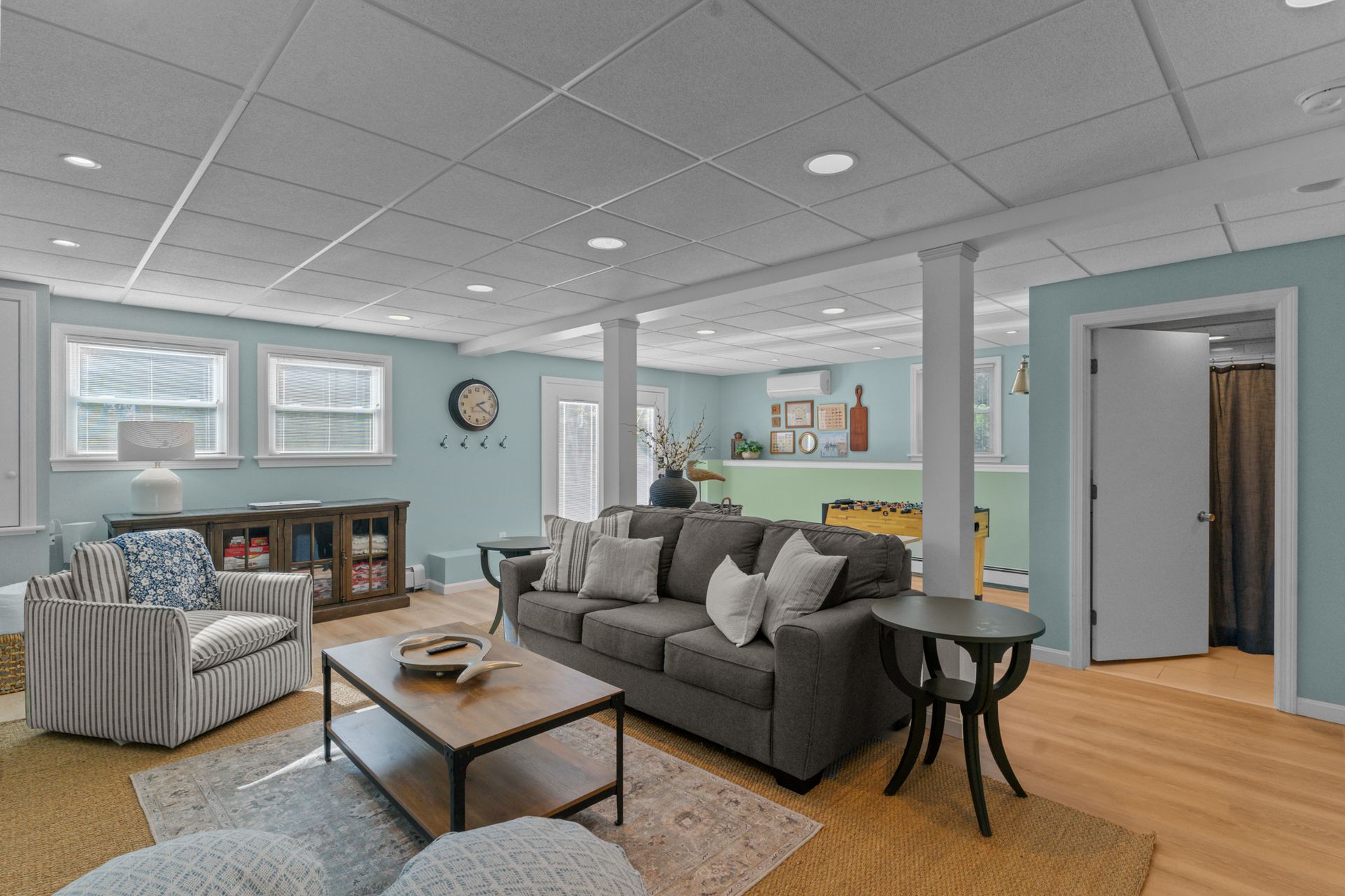 A living room with a couch , chairs , and a coffee table.