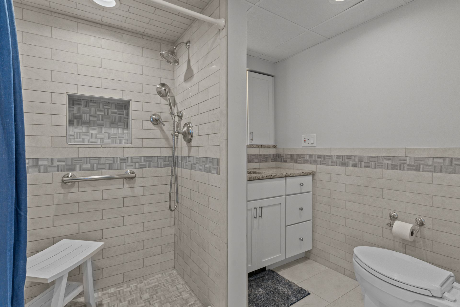A bathroom with a walk in shower and a toilet.