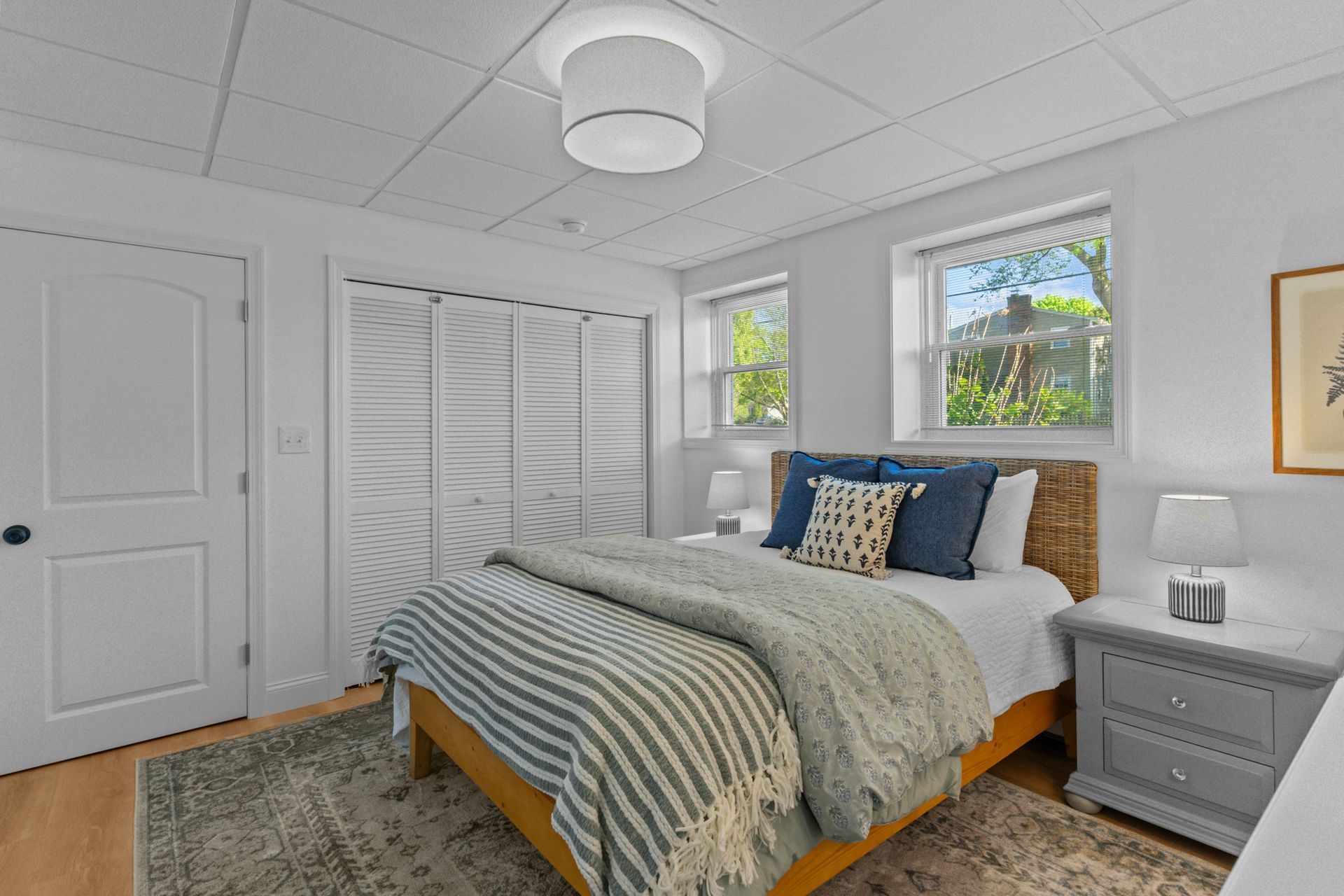 A bedroom with a bed , nightstand , and window.