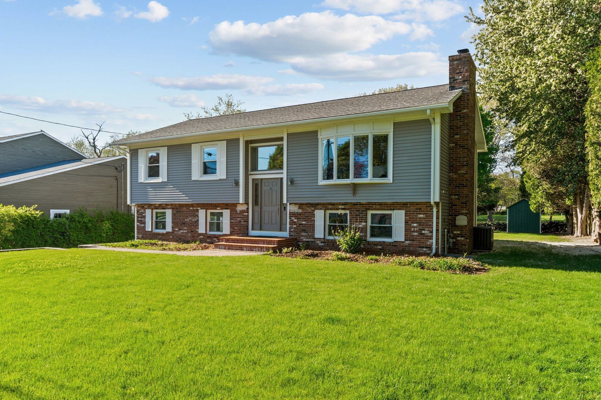A large house with a lush green lawn in front of it.