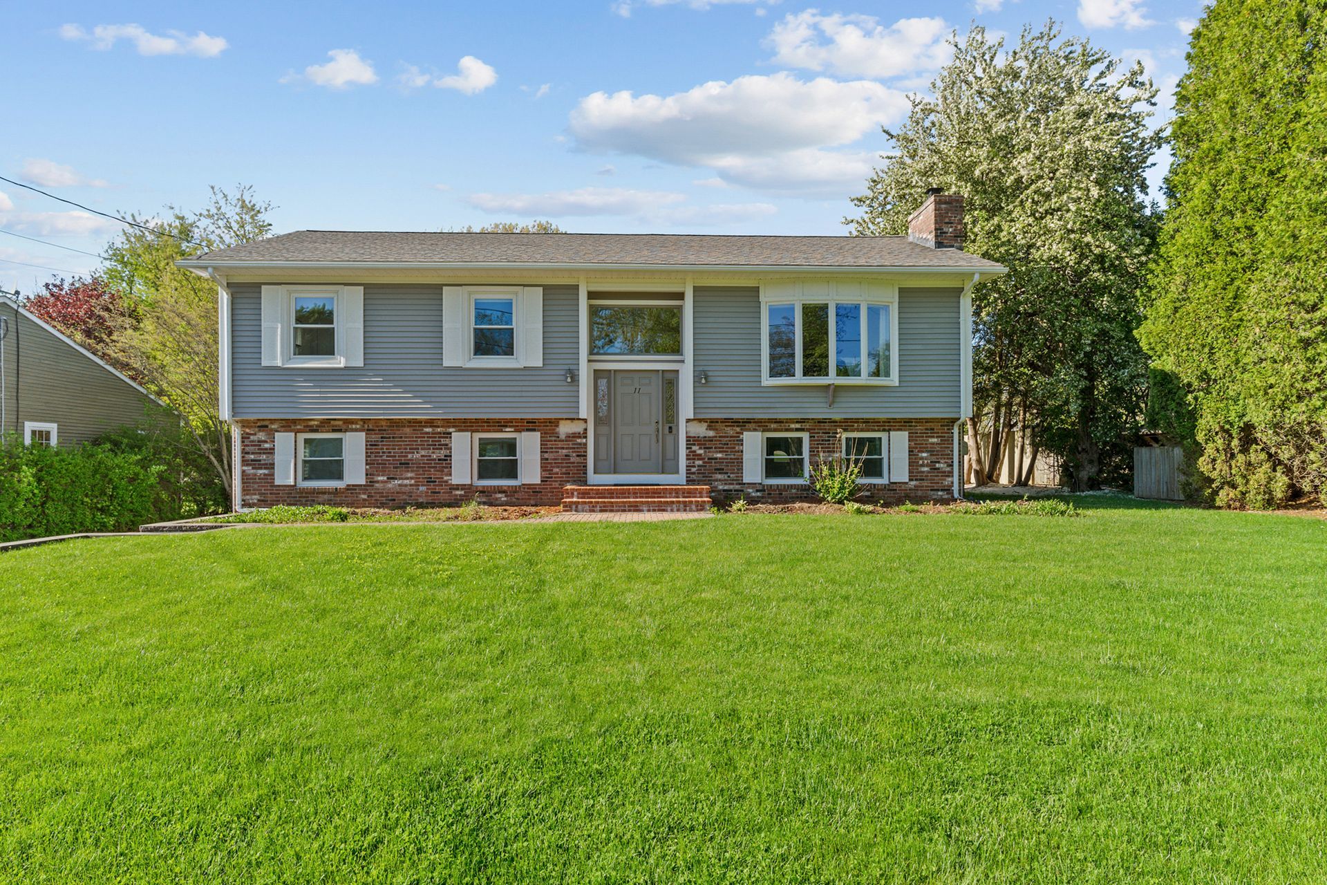 A house with a large lawn in front of it.