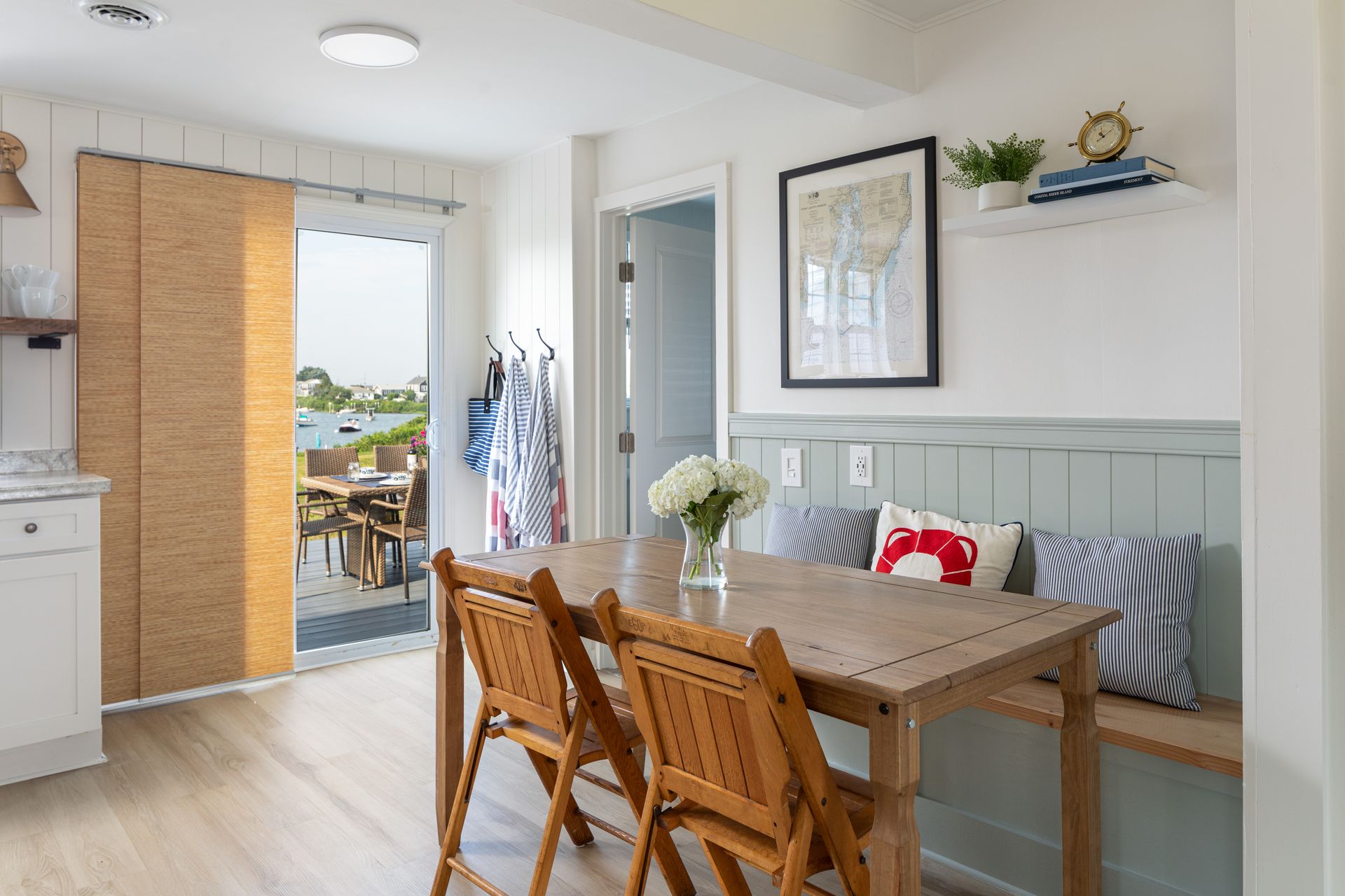 A dining room with a table and chairs and a bench.
