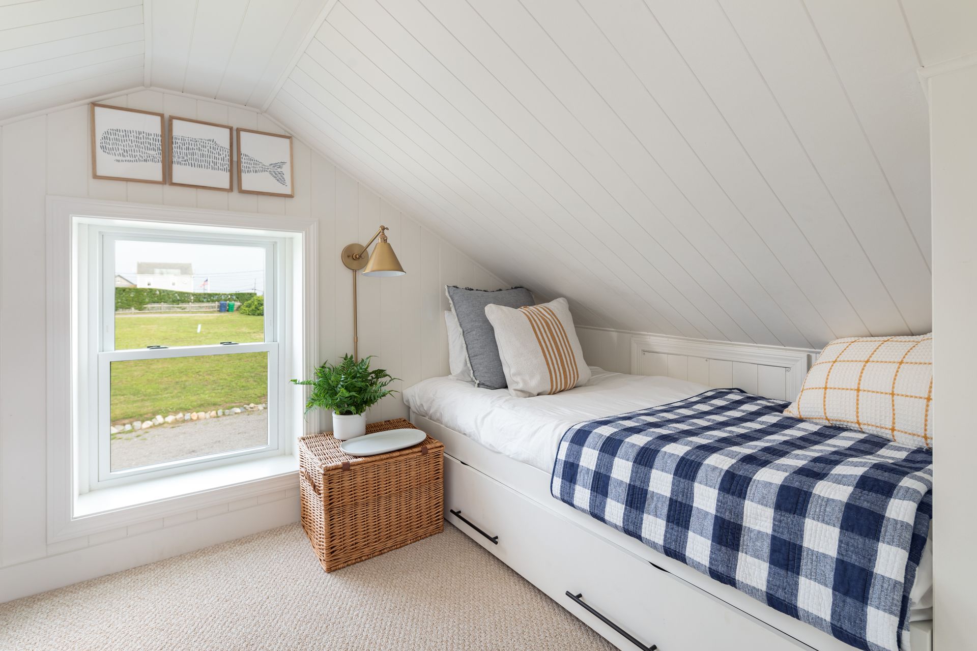 There is a bed in the corner of the room with a window.