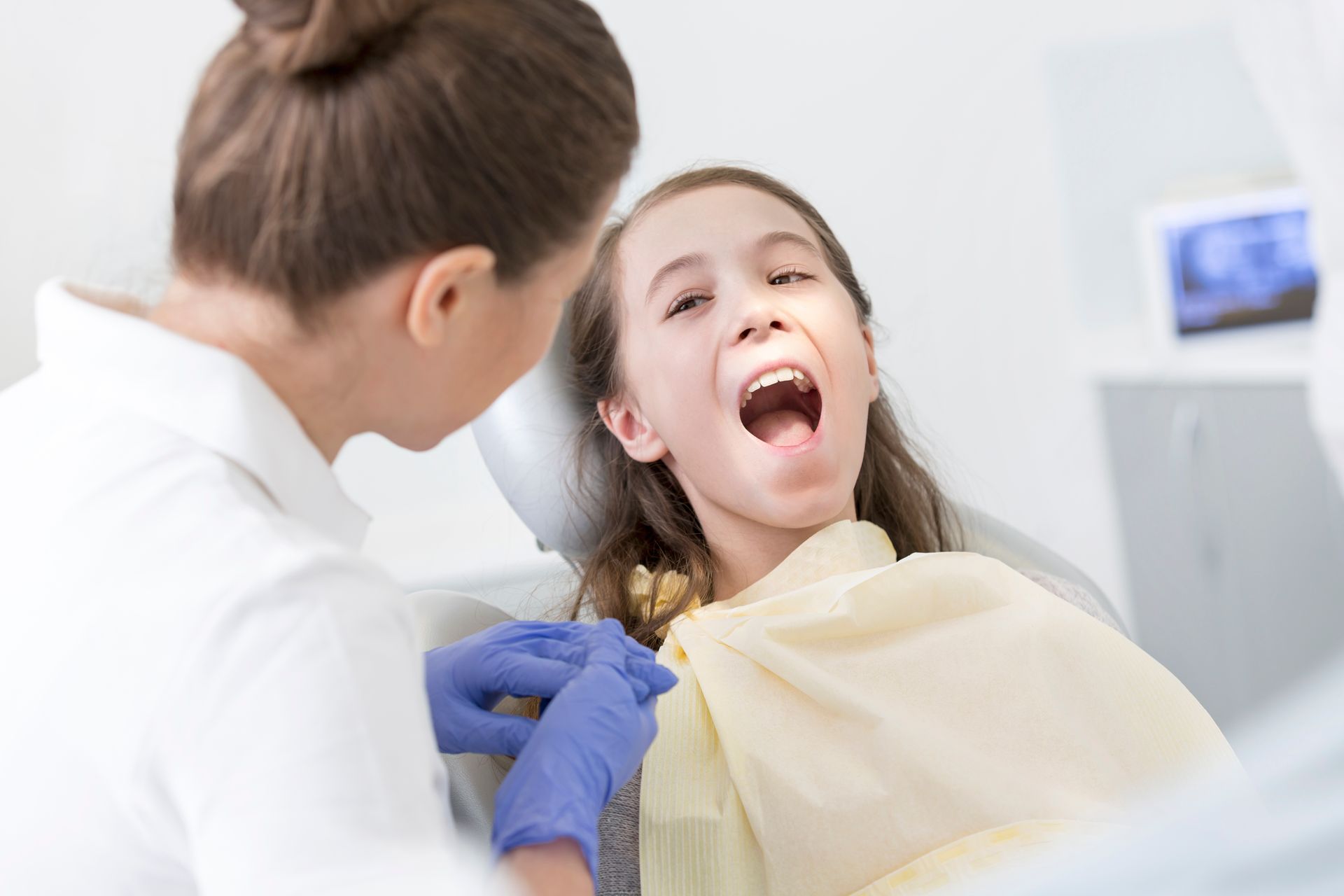 Doctor Checking the Girl's Teeth — Mermaid Waters, QLD — Gold Coast Dental & Denture Centre