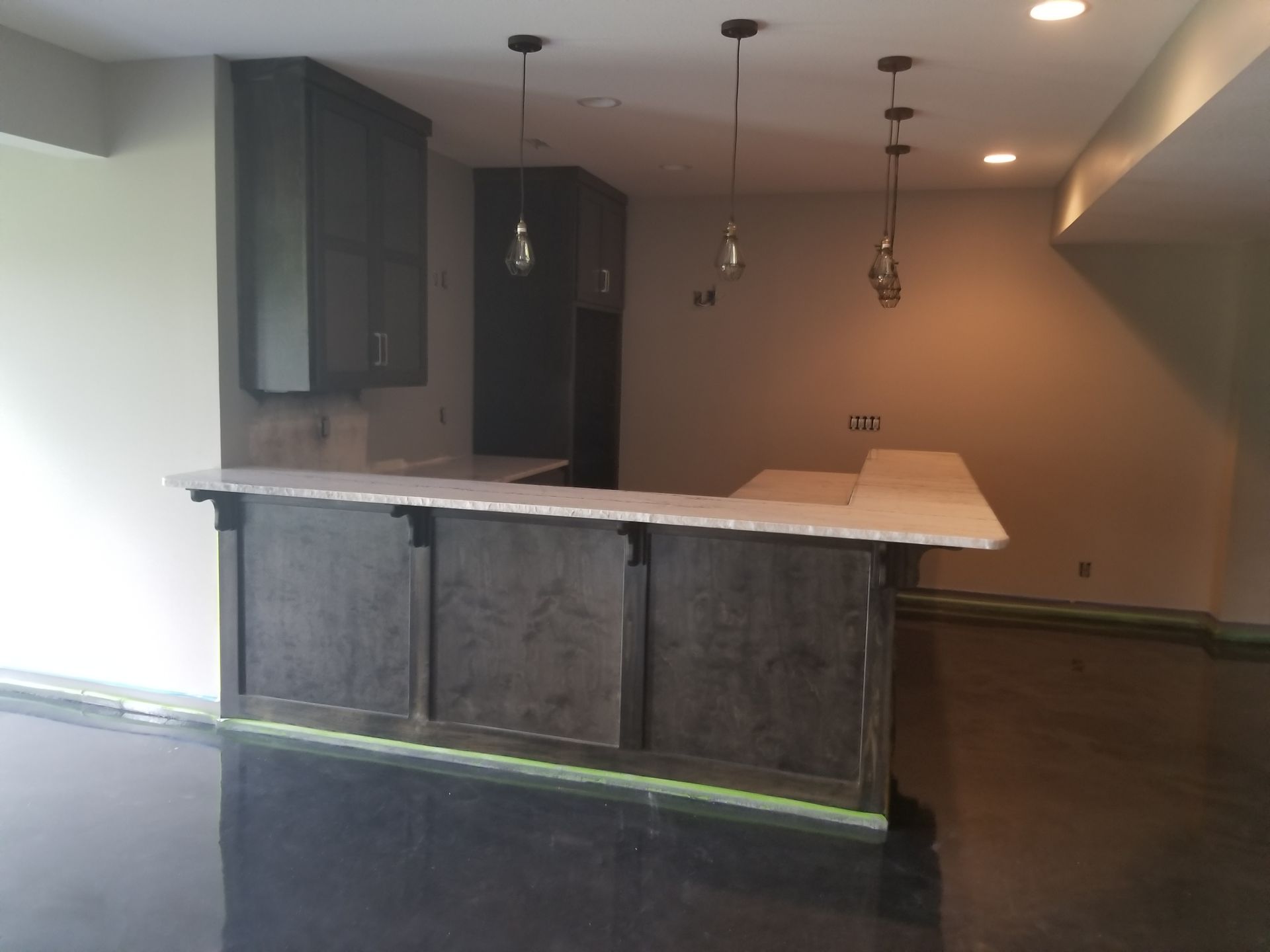 An empty room with a bar in the middle of it