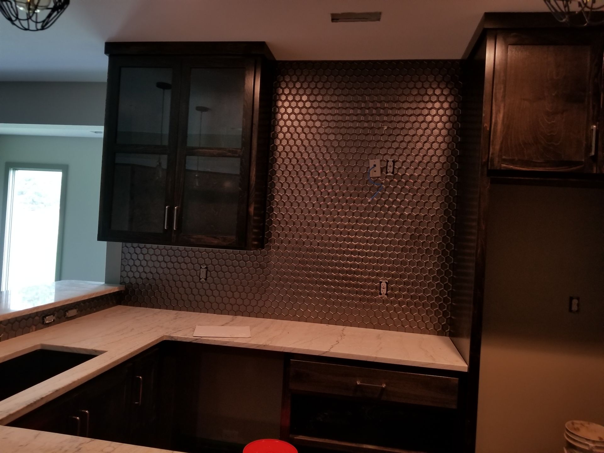A kitchen with black cabinets and white counter tops