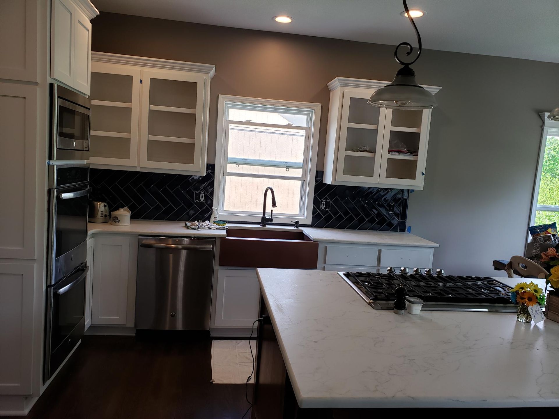 A kitchen with white cabinets and stainless steel appliances