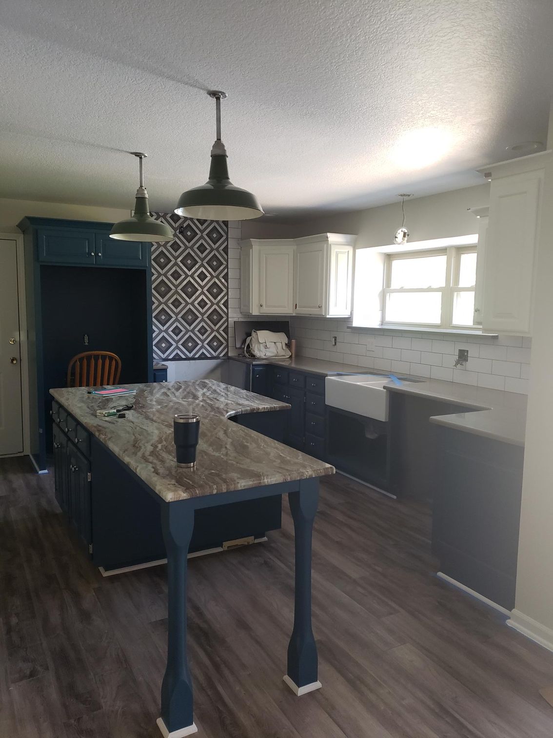 A kitchen with a large island in the middle of it.