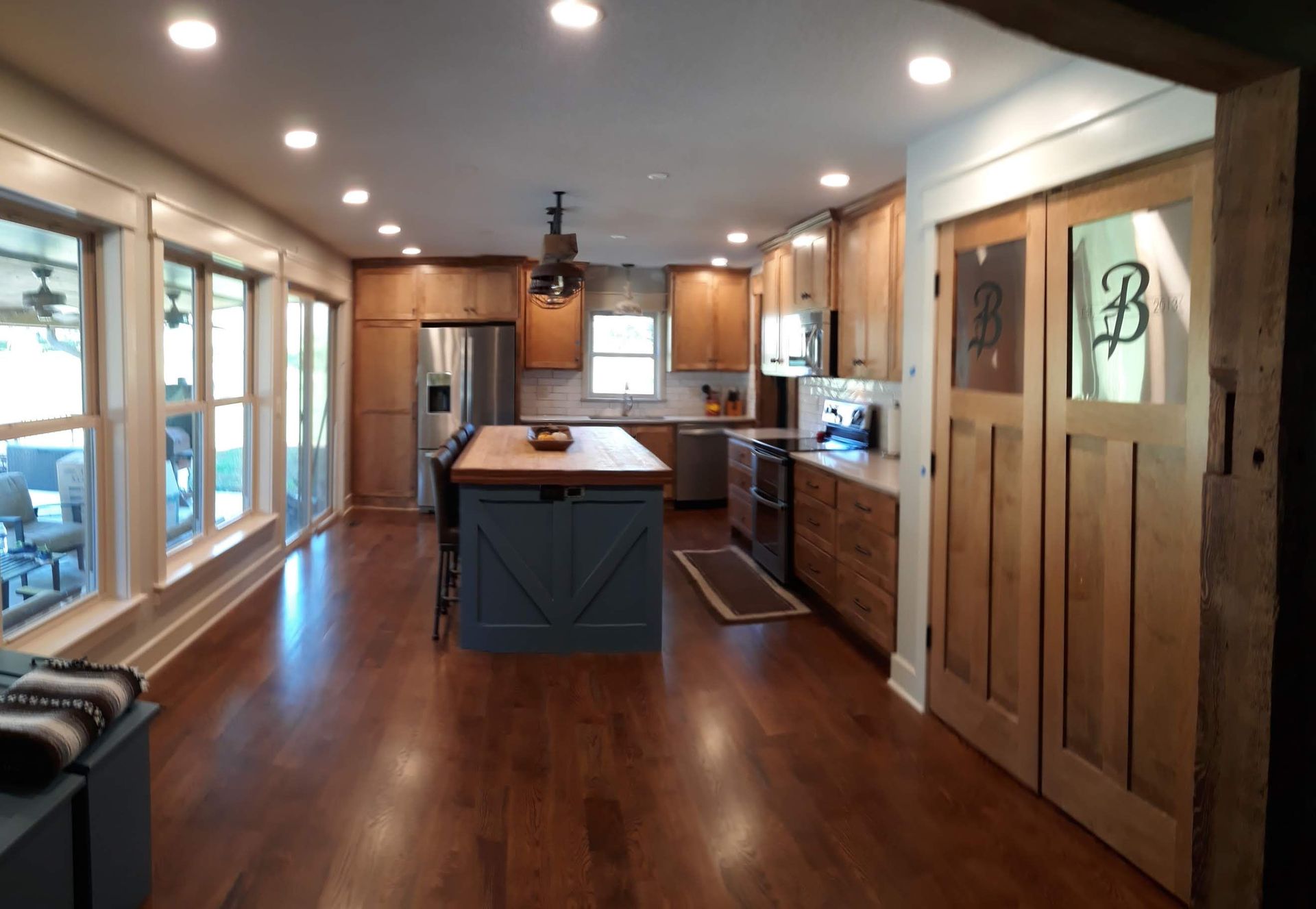 A kitchen with a large island and lots of windows