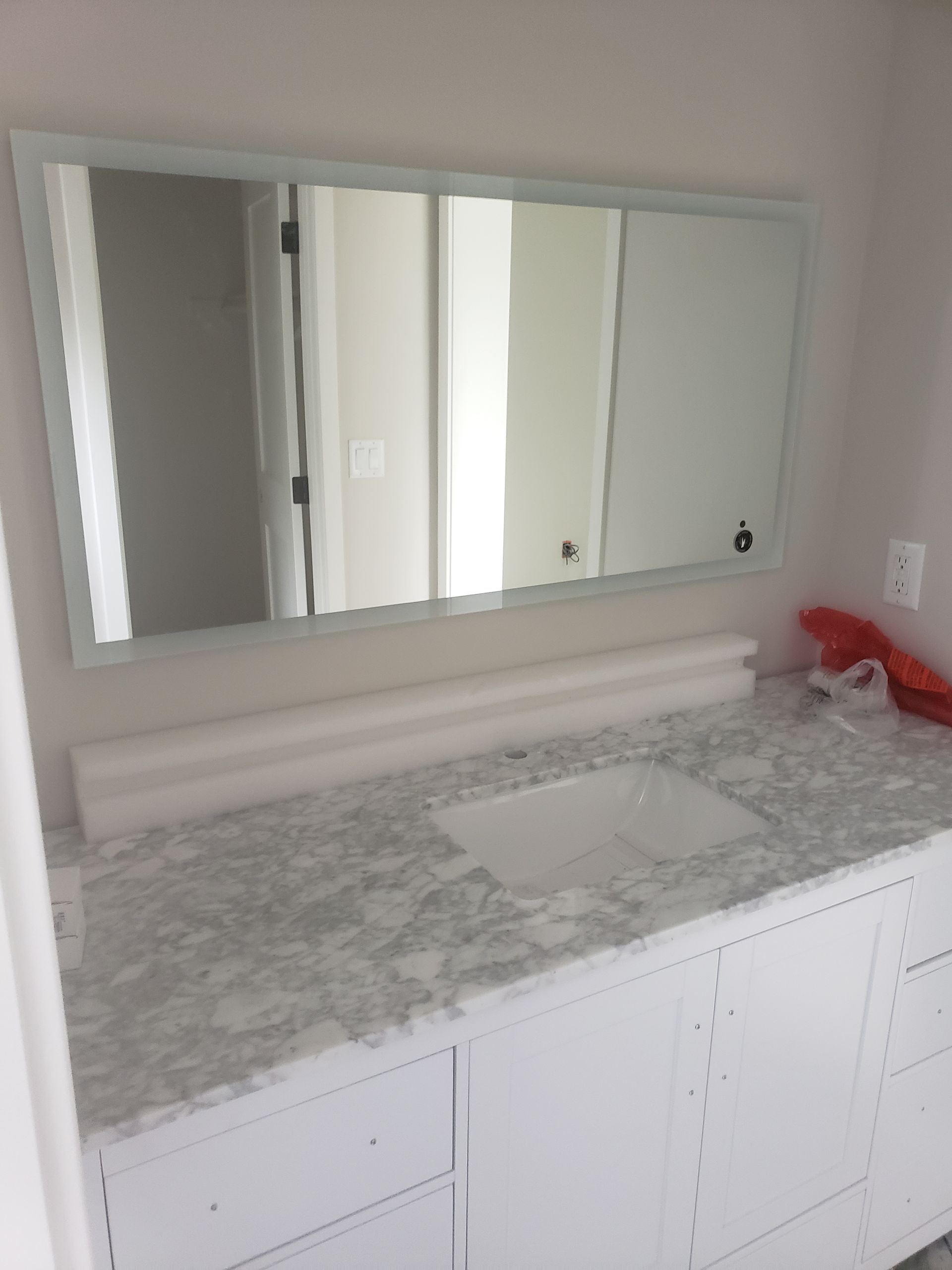 A bathroom with a sink and a large mirror