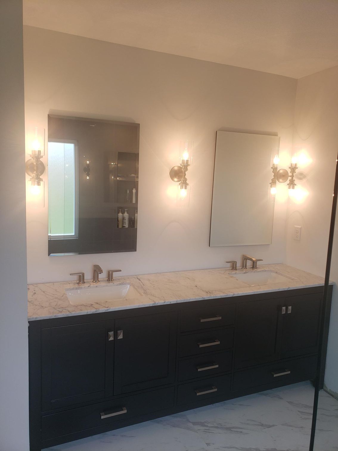 A bathroom with two sinks and a large mirror.