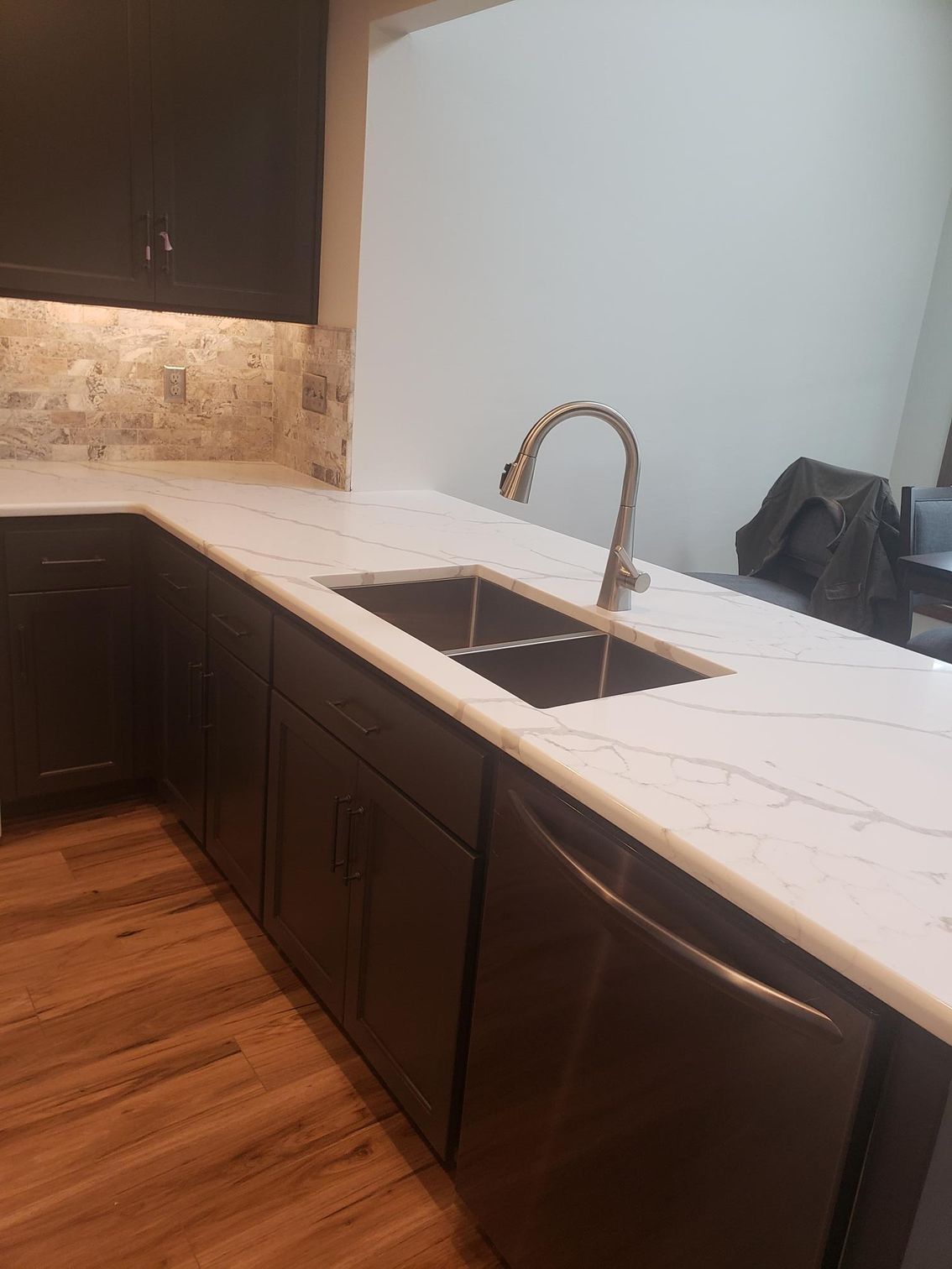 A kitchen with a sink and a faucet on the counter.