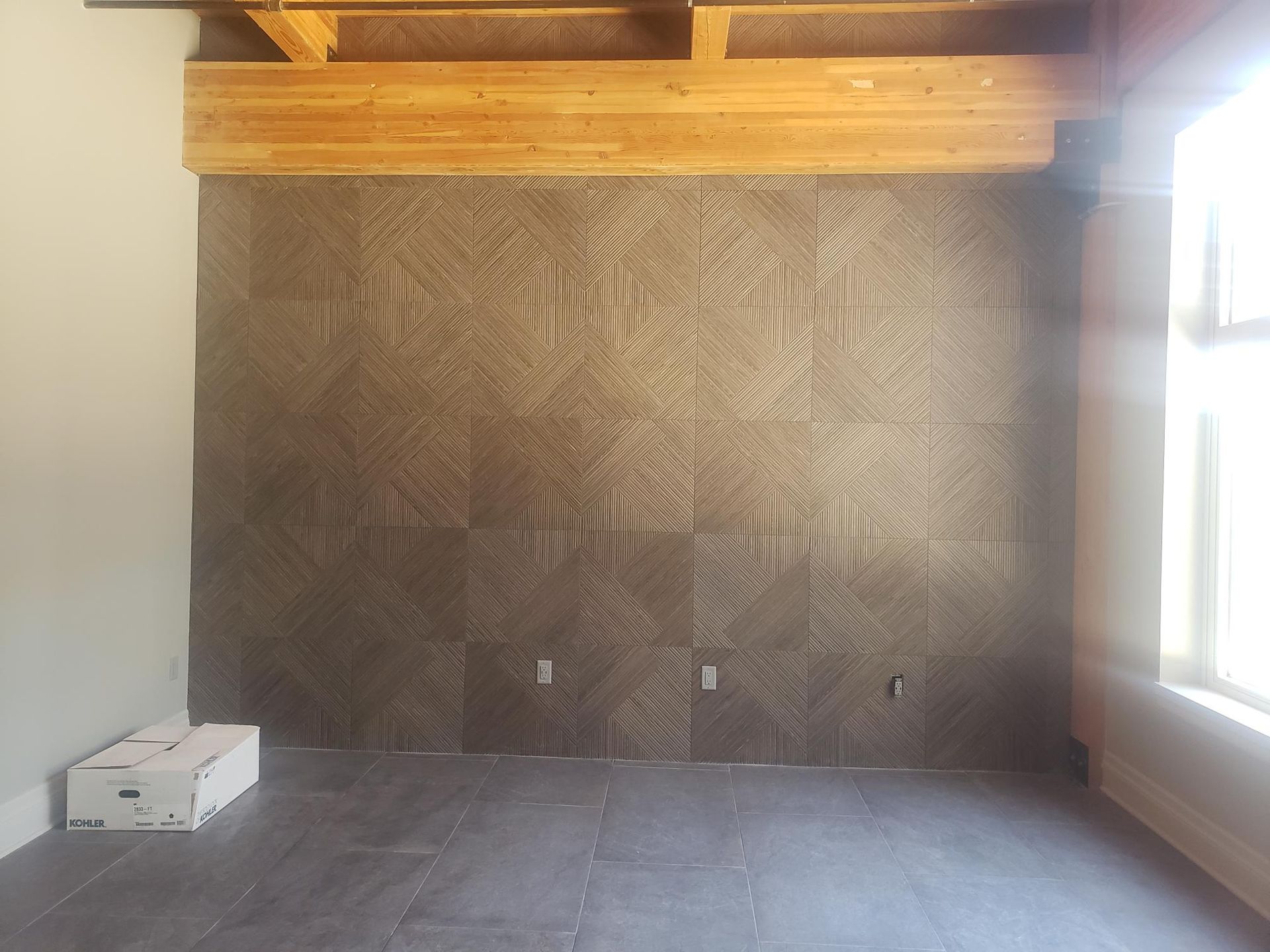 An empty room with a geometric pattern on the wall