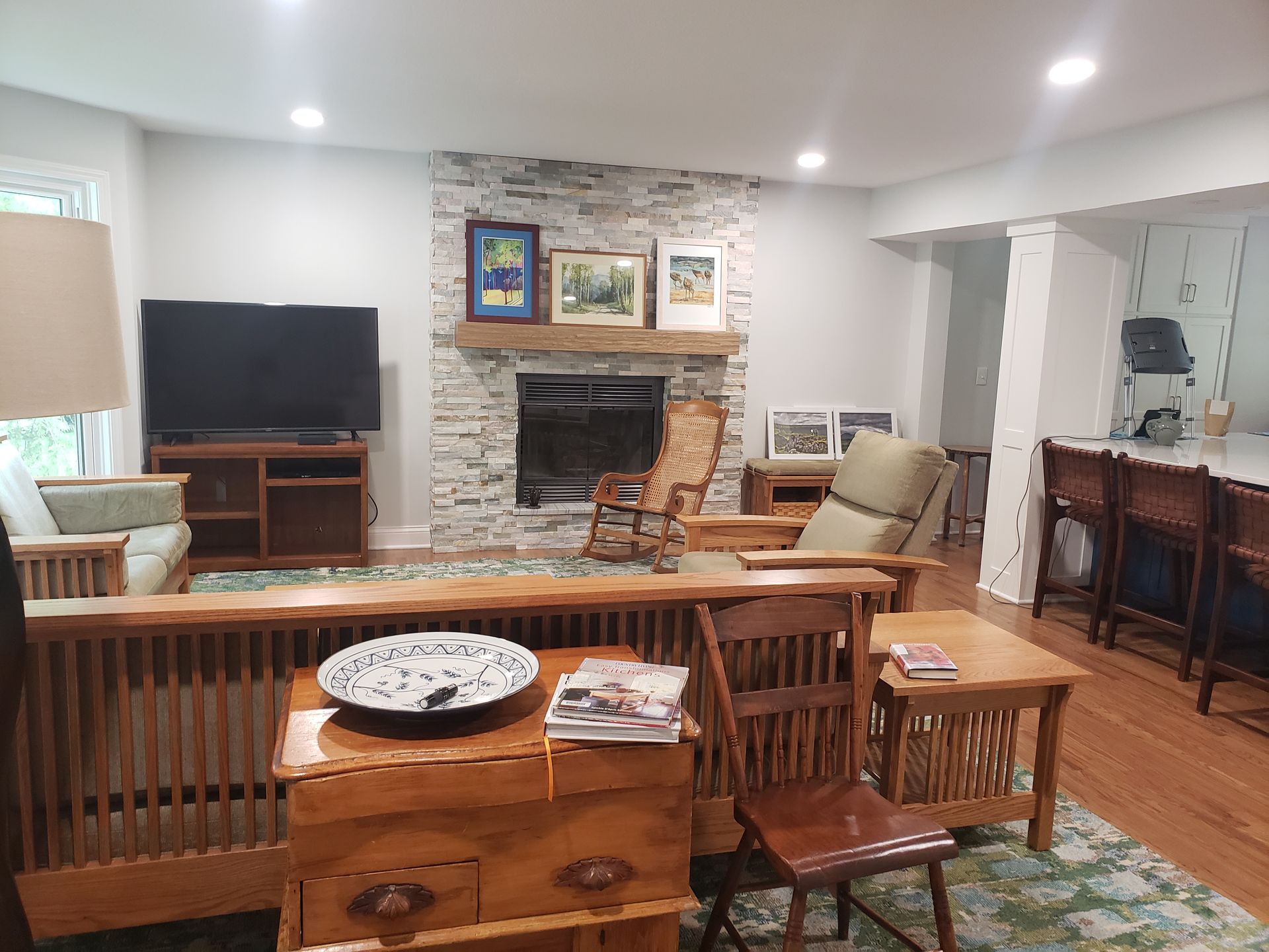 A living room with a fireplace and a flat screen tv.
