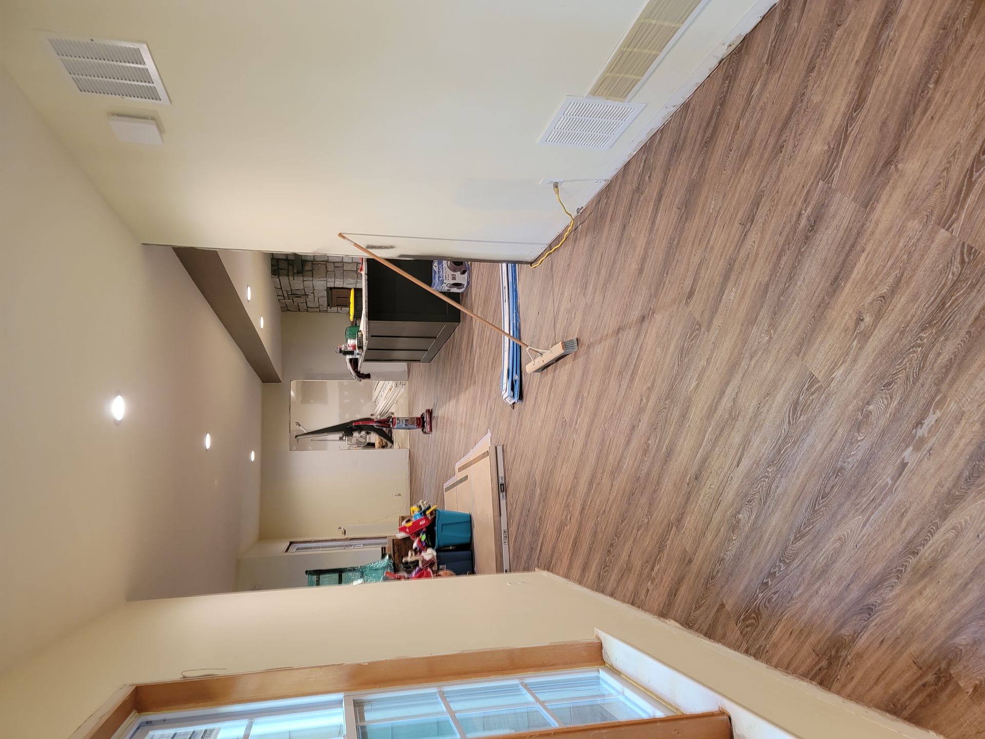 A room with a wooden floor and a window.