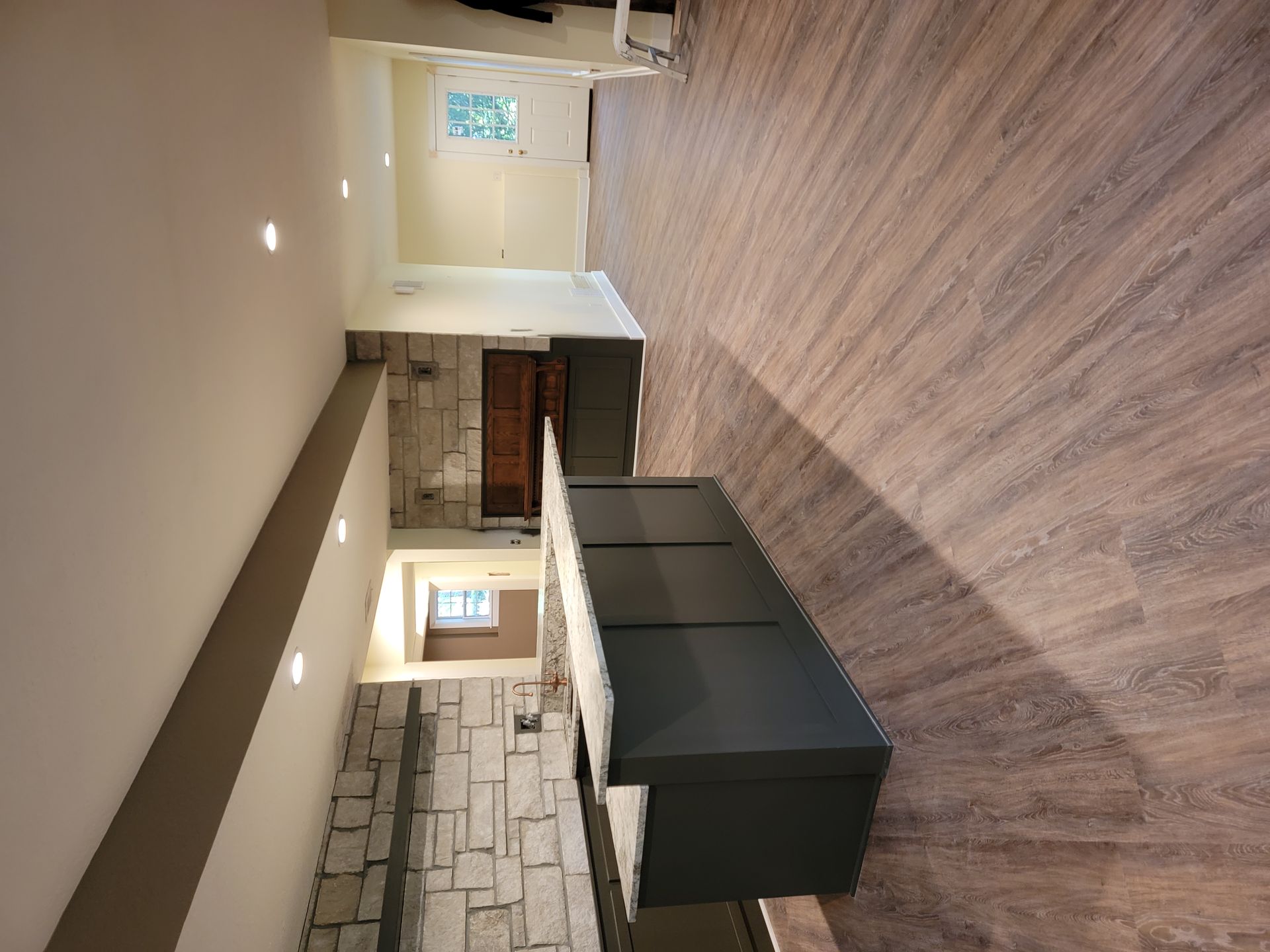 A living room with hardwood floors and a fireplace.