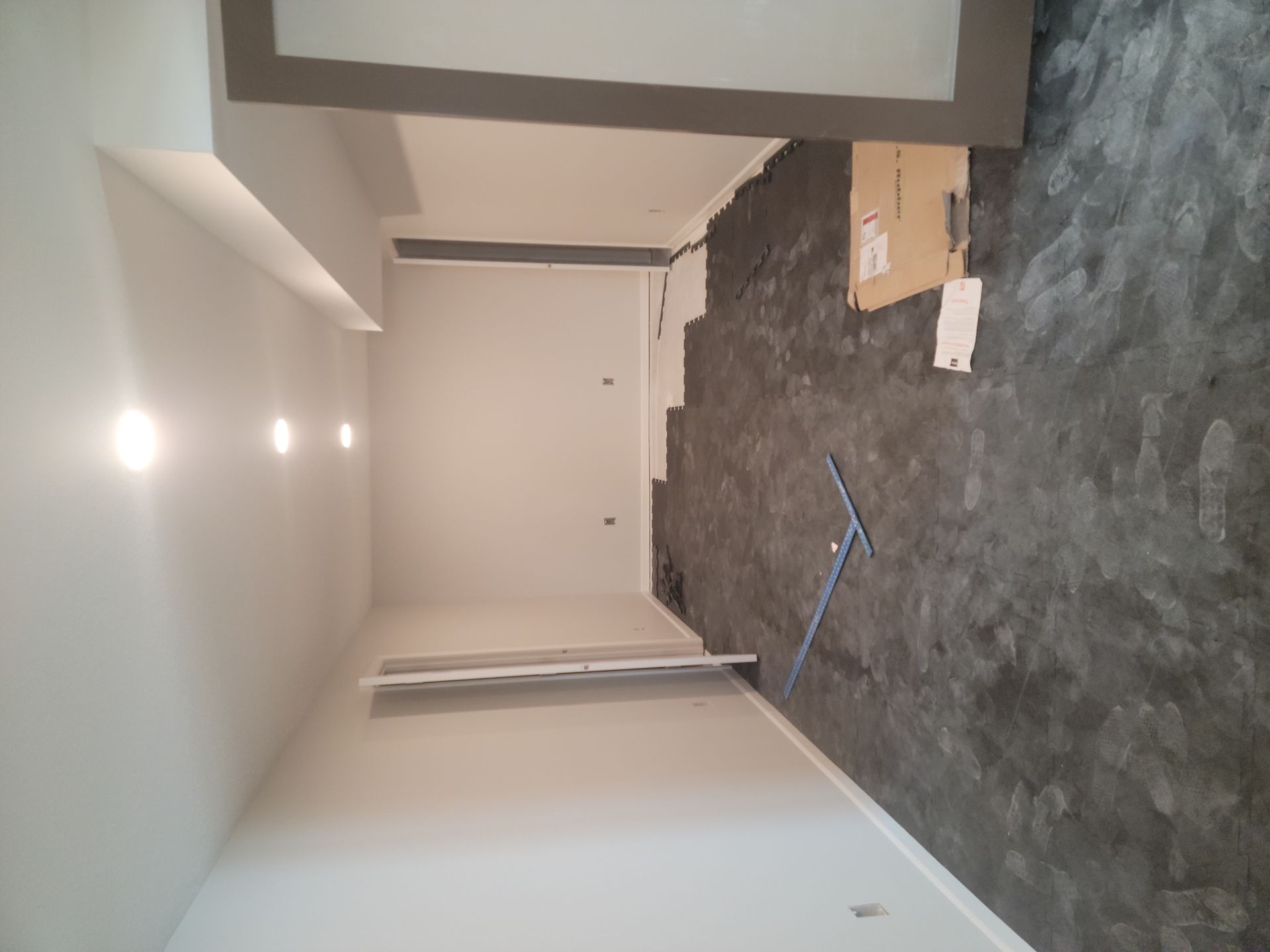 A room with a carpeted floor and white walls.