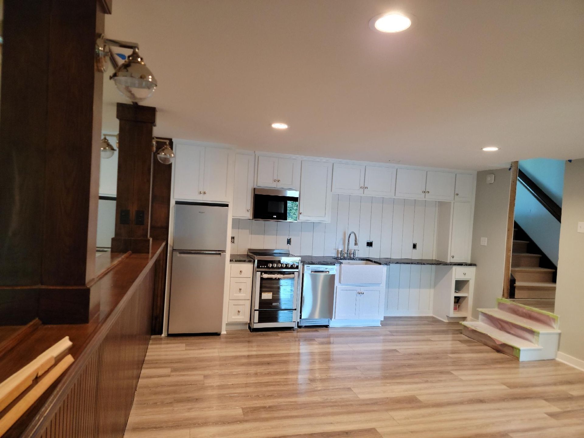 A kitchen with white cabinets and stainless steel appliances