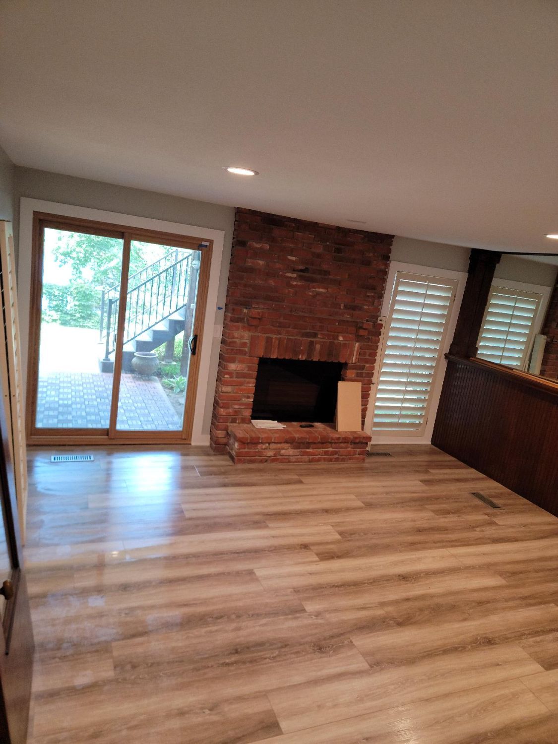 A living room with a fireplace and sliding glass doors.