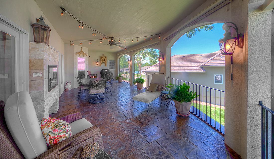 There is a large porch with a view of the backyard.