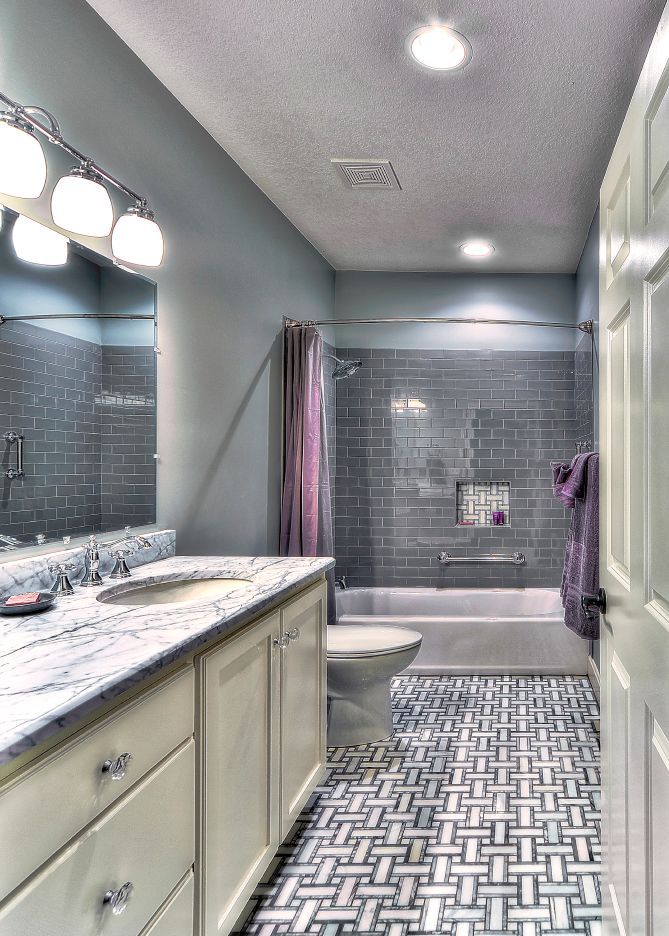 A bathroom with a sink , toilet , and shower.