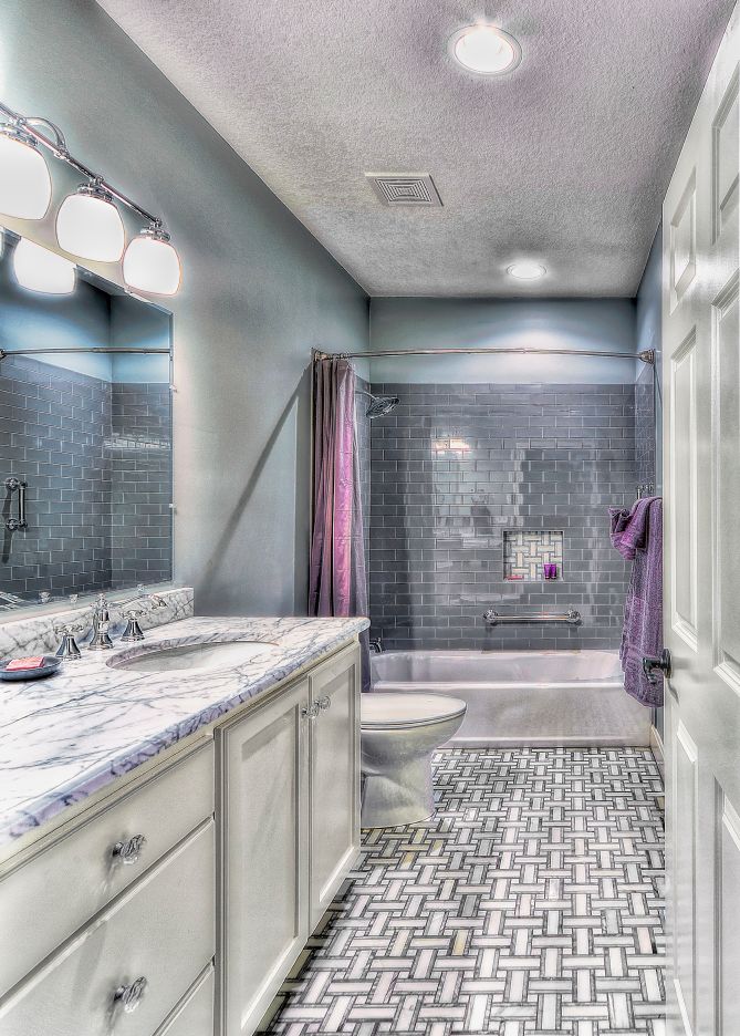 A bathroom with a sink , toilet , and shower.