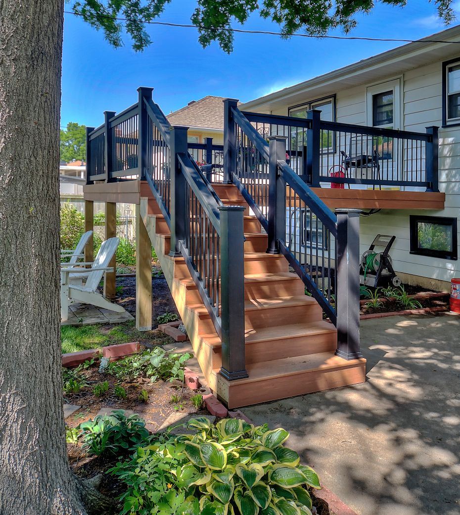 A house with a deck and stairs leading up to it