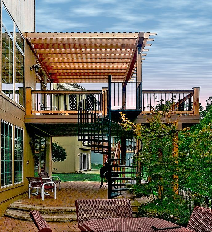 A deck with a spiral staircase leading up to it