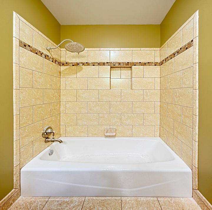 A bathtub in a bathroom with a shower head