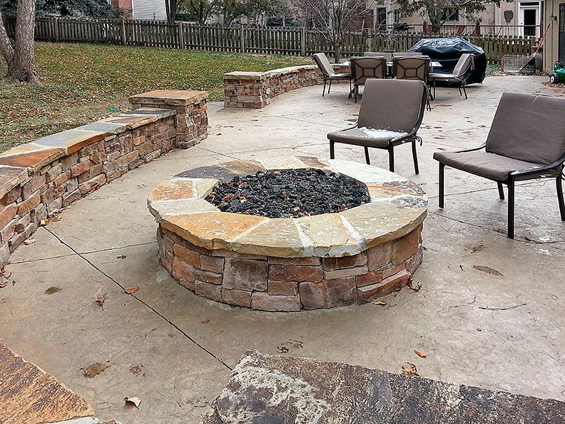 There is a fire pit in the middle of the patio.