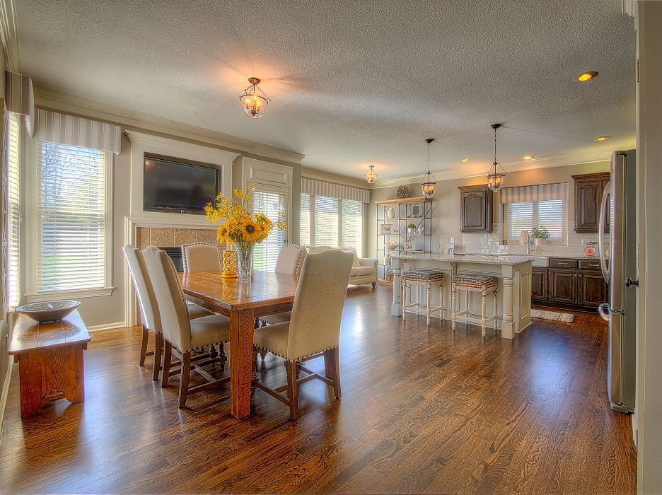 There is a dining table and chairs in the middle of the room.