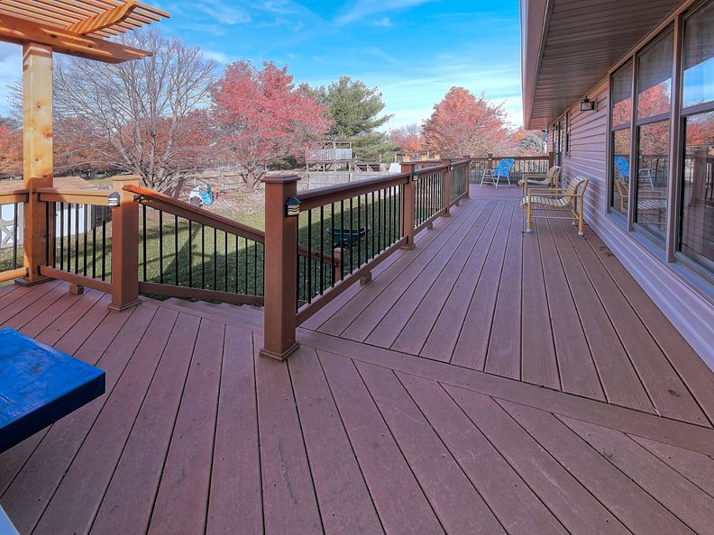 A large wooden deck with stairs leading up to it