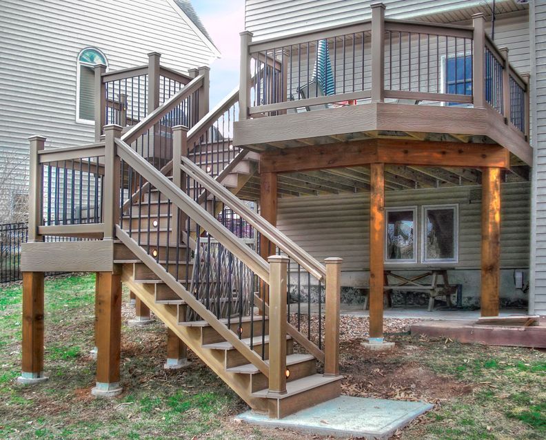 A wooden deck with stairs leading up to it