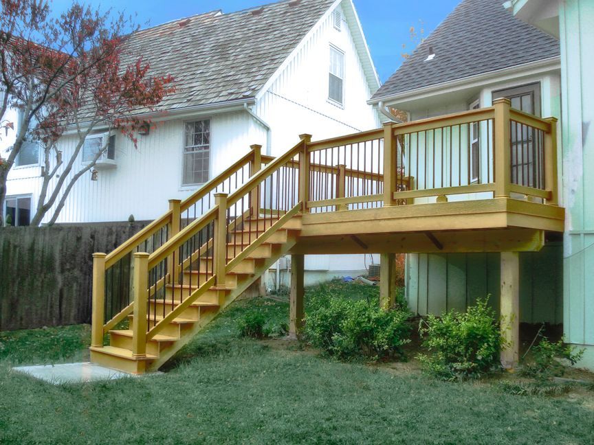 A wooden deck with stairs leading up to it